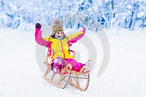 Kids play in snow. Winter sleigh ride for children