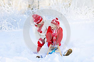 Kids play in snow. Winter sleigh ride for children