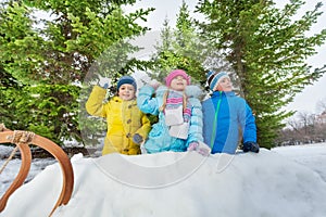 Kids play snowball inside snow fortress in park