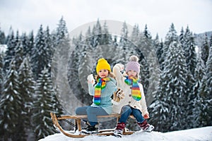 Kids play snowball, snow ball fight for children. Children son and daughter play in snow in winter. Outdoor kids fun for