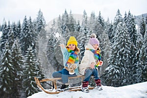 Kids play snowball, snow ball fight for children. Christmas winter holidays and happy New Year for kids. Winter children