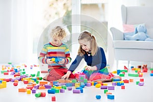 Kids play with toy blocks. Toys for children.