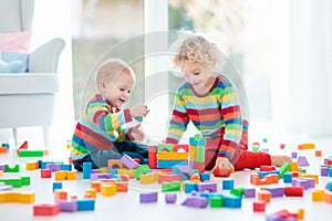 Kids play with toy blocks. Toys for children.
