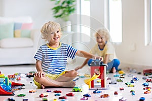 Kids play with toy cars. Children playing car toys