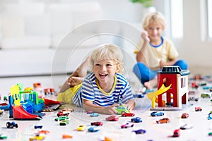 Kids play with toy cars. Children playing car toys