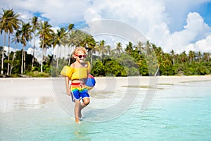 Kids play on tropical beach. Sand and water toy