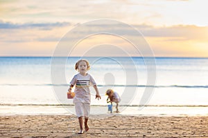 Kids play on tropical beach. Sand and water toy