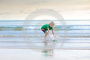 Kids play on tropical beach. Sand and water toy