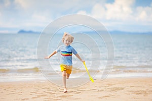 Kids play on tropical beach. Sand and water toy
