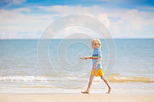 Kids play on tropical beach. Sand and water toy