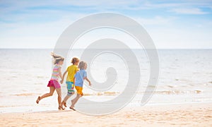 Kids play on tropical beach. Sand and water toy