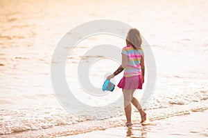 Kids play on tropical beach. Sand and water toy