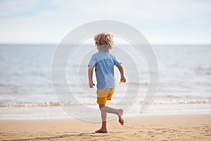 Kids play on tropical beach. Sand and water toy