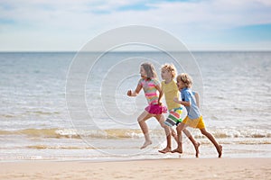 Kids play on tropical beach. Sand and water toy