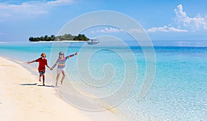 Kids play on tropical beach. Sand and water toy