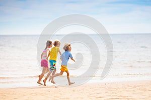 Kids play on tropical beach. Sand and water toy