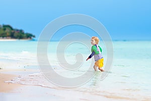 Kids play on tropical beach. Sand and water toy.