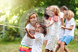 Kids play tug of war. Children pull rope