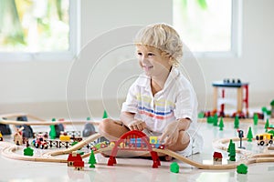 Kids play wooden railway. Child with toy train