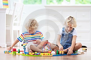 Kids play wooden railway. Child with toy train