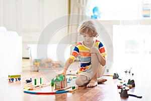 Kids play wooden railway. Child with toy train