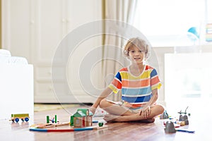 Kids play wooden railway. Child with toy train