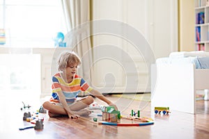 Kids play wooden railway. Child with toy train