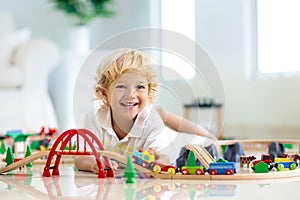 Kids play wooden railway. Child with toy train