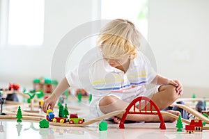 Kids play wooden railway. Child with toy train