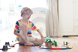 Kids play wooden railway. Child with toy train