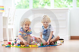 Kids play wooden railway. Child with toy train