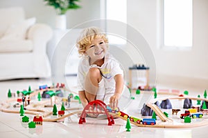 Kids play wooden railway. Child with toy train