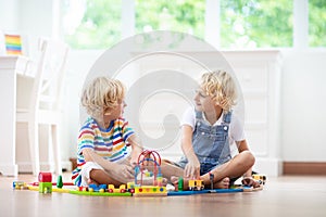 Kids play wooden railway. Child with toy train