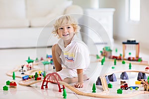 Kids play wooden railway. Child with toy train