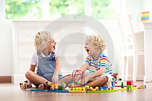 Kids play wooden railway. Child with toy train