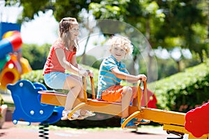 Kids on playground. Children play in summer park.