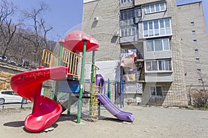 Kids playground near a residential building in a sunny day in spring. Nobody on the playground. Life in Russia concept. Russia,