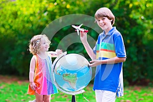 Kids playing with airplanes and globe