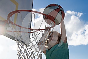 Kids playing basketball. Child sport activity. Healthy children lifestyle. Closeup face of kid basketball player making