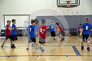 Kids playing basketball match