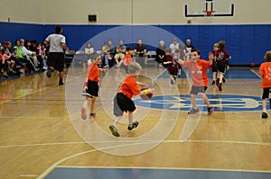 Kids playing basketball match