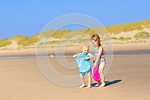 Kids playing on beach. Children play at sea