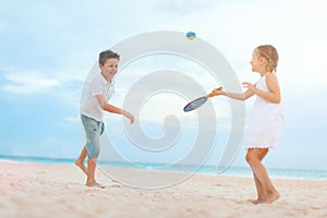 Kids playing beach tennis