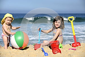 Kids playing with beach toys in the sand