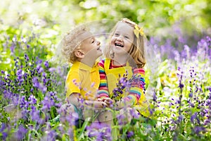 Kids playing in blooming garden with bluebell flowers