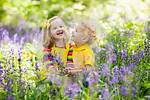 Kids playing in blooming garden with bluebell flowers