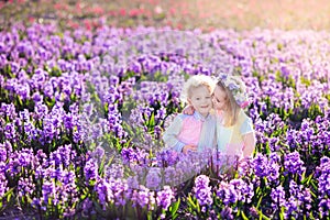 Kids playing in blooming garden with hyacinth flowers
