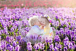 Kids playing in blooming garden with hyacinth flowers