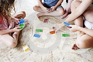 Kids playing cards on the floor