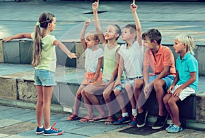 Kids playing charades outdoors